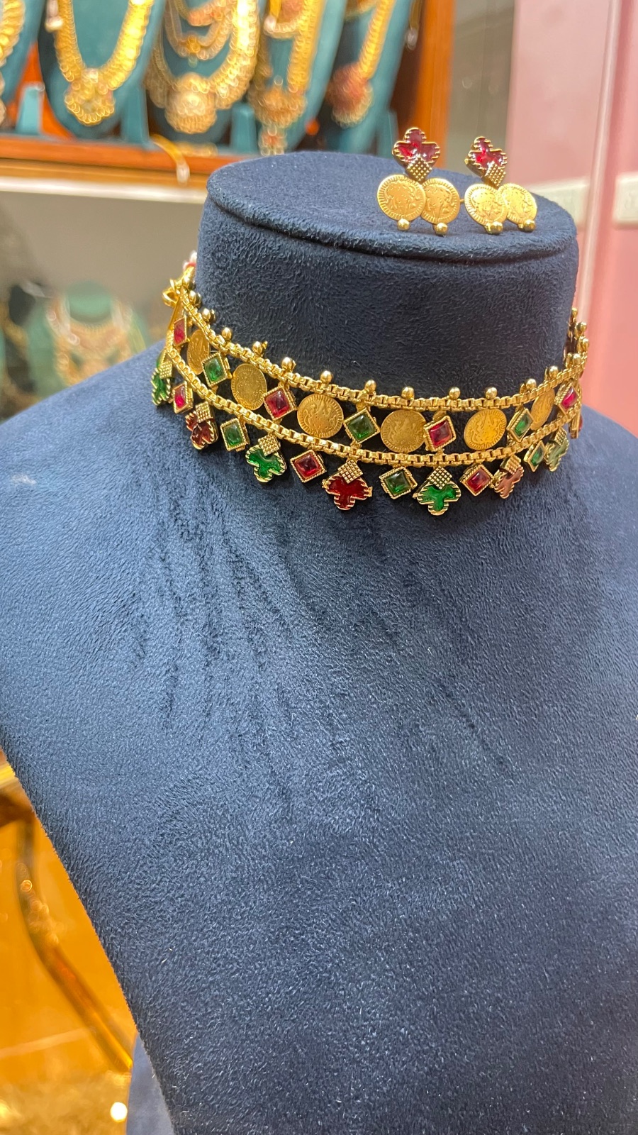 small coins with red and green diamond shape stone